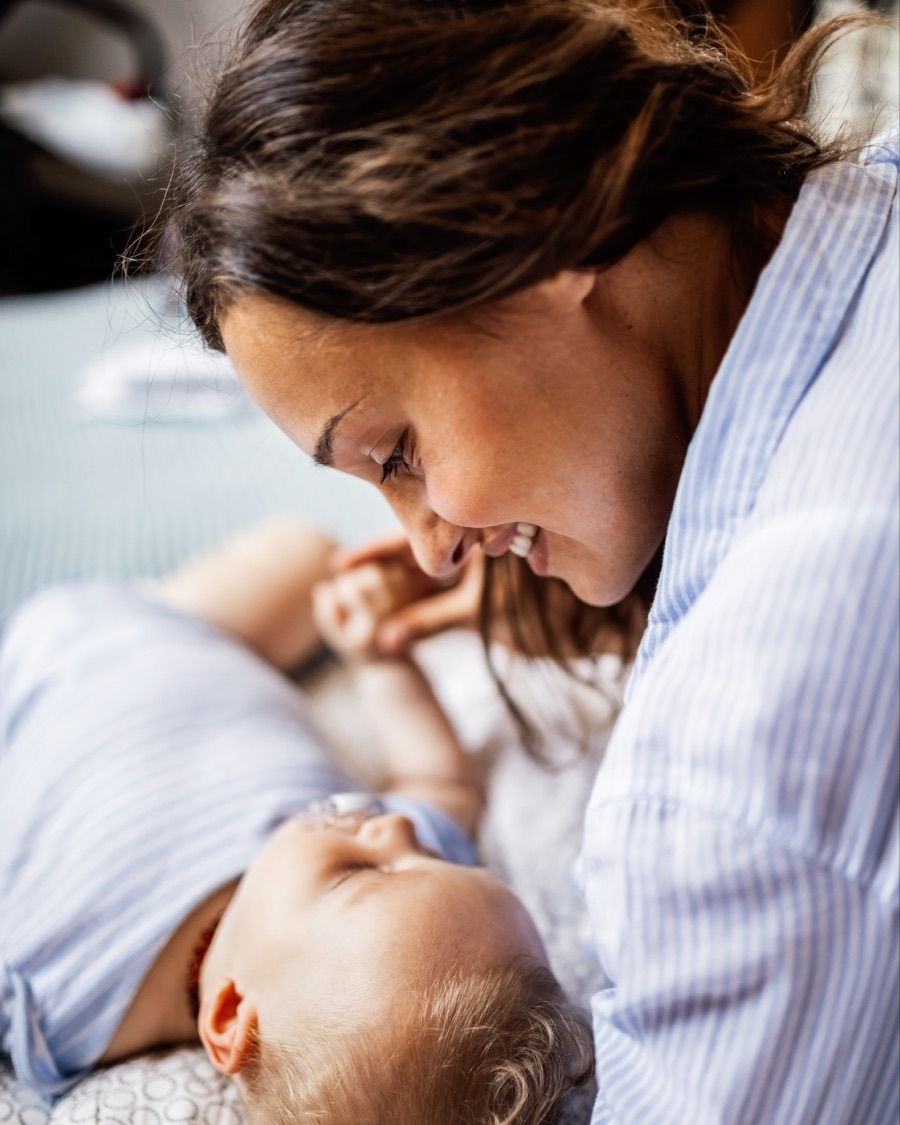 A new mum smiling down at her baby as the lullaby plays